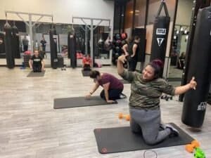 Women practicing boxing techniques at Fightgirl Fitness gym.