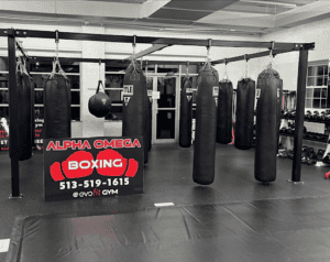 Boxing gym with punching bags and training equipment at Alpha Omega Boxing.