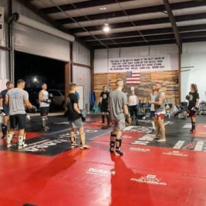 Muay Thai fighters practicing techniques in a training gym at Mazu Muay Thai.