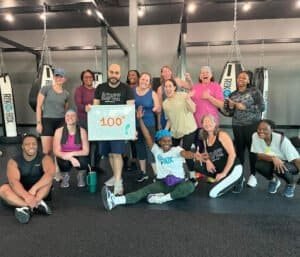 Group of diverse people celebrating at RockBox Fitness Winston-Salem gym.
