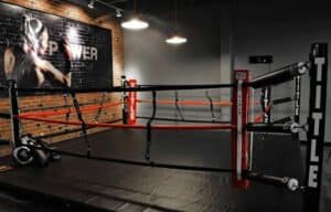Indoor boxing ring with training equipment at TITLE Boxing Club Trexlertown.