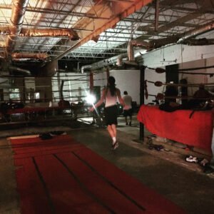 Boxing gym interior with training area and boxing ring at Holly Rock.