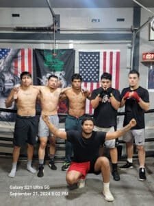 Group of male boxers training at Liberal Boxing Club gym.