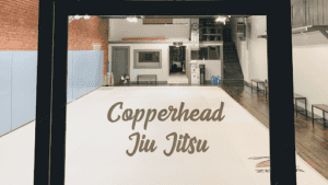 Indoor jiu jitsu training space with mats and equipment at Copperhead Jiu Jitsu.