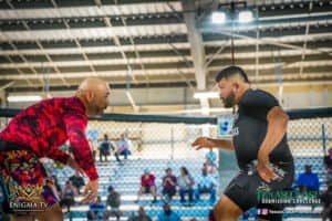 Two male fighters sparring inside a boxing ring at Castano BJJ gym.