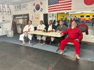 Martial arts class at The Blackbelt Academy of Uvalde with diverse students in uniform.
