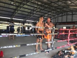 Two fighters in training at Audacious Muay Thai Academy boxing ring.
