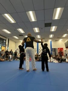 Instructor teaching Brazilian Jiu Jitsu to children at Apex Academy.