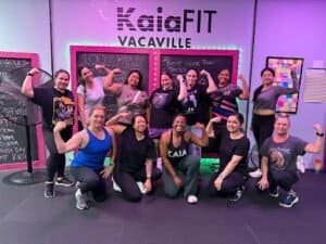 Group of women flexing muscles after workout at Kaia Fit Vacaville.