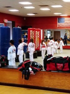 Kids in martial arts uniforms practicing at Hong's Martial Arts School.
