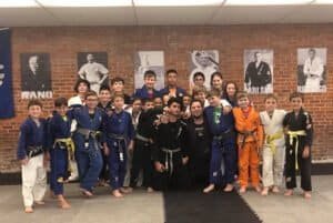 Young students practicing Jiu-Jitsu in a martial arts class at Gladiators Academy.