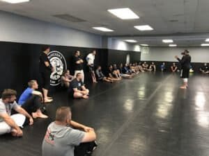 Martial arts instructor teaching students in a training session at McVicker's Martial Arts.