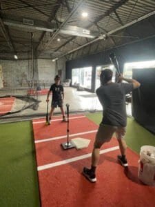 Young boy practicing boxing with trainer at JP Performance Training.