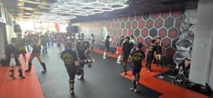 Muay Thai fighters practicing techniques in a modern gym in Waco.