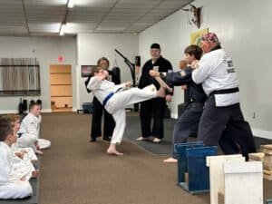 Kids practicing martial arts kick during training at ATF Martial Arts Academy.