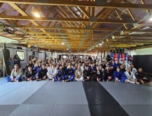 Group of students and instructors in a Jiu Jitsu training session.
