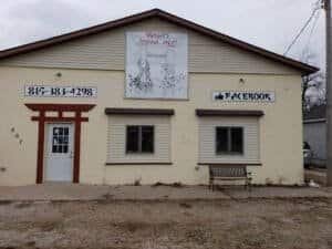 Exterior view of Wright's Shoto-Jitsu and Defense Tactics studio with signage and bench.
