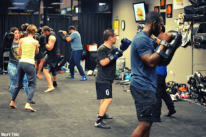 Group practicing Muay Thai and boxing techniques at Fighting Fit gym.