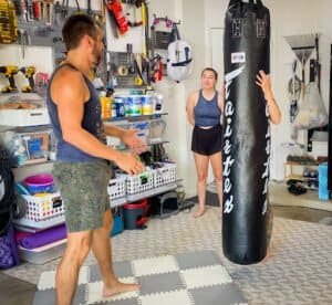 Boxing training session at Austin Fight Team gym with coach and student.
