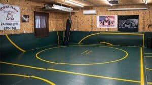 MMA training area with padded floor and punching bag at Mack Training Academy.