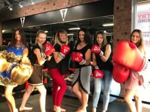 Group of women in boxing gloves at TITLE Boxing Club West Bloomfield.