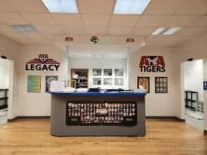 Reception desk at Engage Martial Arts in Kittanning with ATA and Tigers logos.