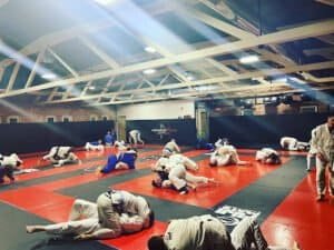 Martial arts students practicing Brazilian Jiu-Jitsu techniques in Worcester MMA gym.