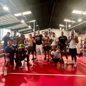Group of boxers and trainers at Dallas Fight Club gym.