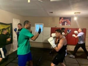 Boxers practicing boxing techniques in a training gym at Empire Boxing.