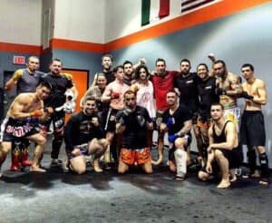 Group of fighters and trainers at Legion Muay Thai gym.