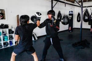 Boxing training session at LaBori Boxing Inc. with coach and student practicing punches.