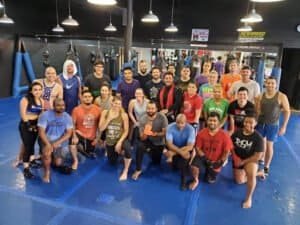 Martial arts class at Hidden Gym with diverse students and instructors.
