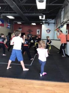 Children practicing martial arts in a class at Ultimate Martial Arts Studio.