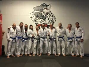 Group of martial artists in gi uniforms at Phil Clark's Martial Arts & Self-Defense Center.
