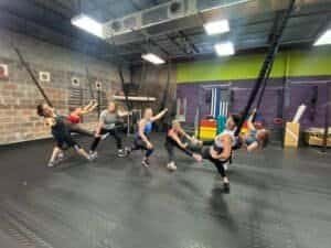 Group fitness class with women doing resistance training at FlexFit Sebring gym.